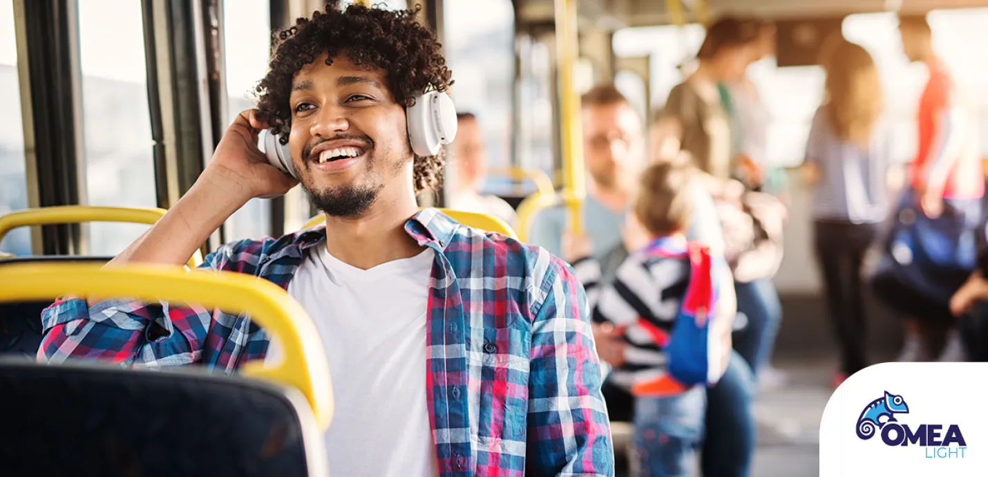 Pic of a man on a bus listening to lusic